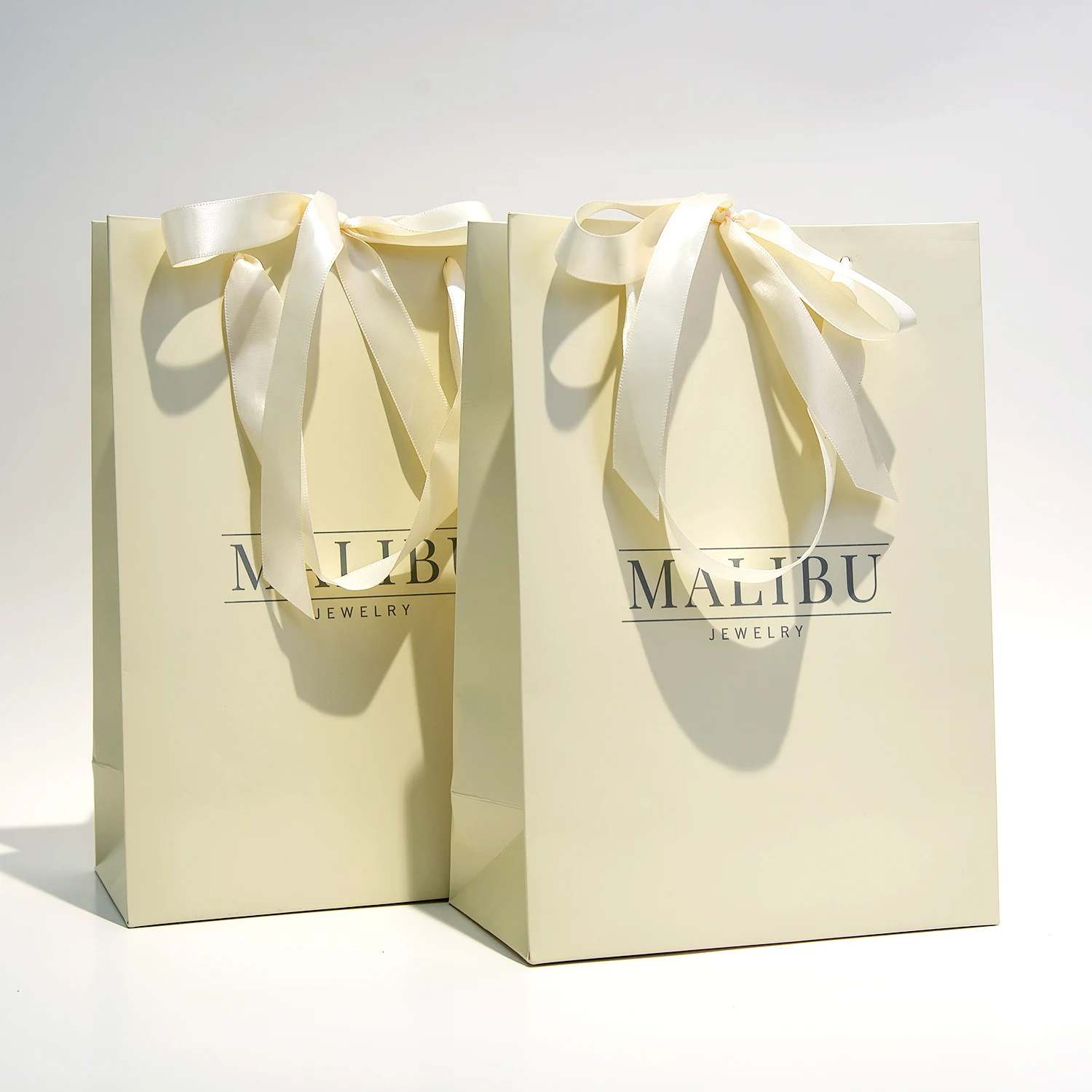 Luxury Custom Screen CMYK Printing Surface Gift Shopping Jewelry Paper Bag Champagne color Paper Bags With Bow Ribbon