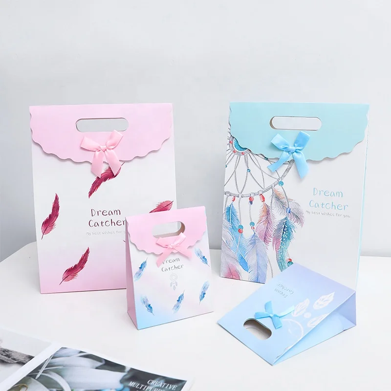
New feather pattern clamshell high-end fashion clothing shopping tote bag gift white card paper bag customization spot 