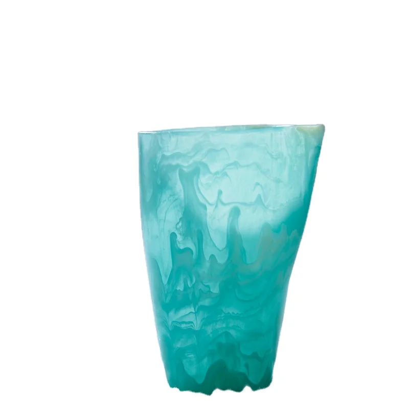 Unique handmade resin cup with aqua swirl and marble effect which is able to contain water ice