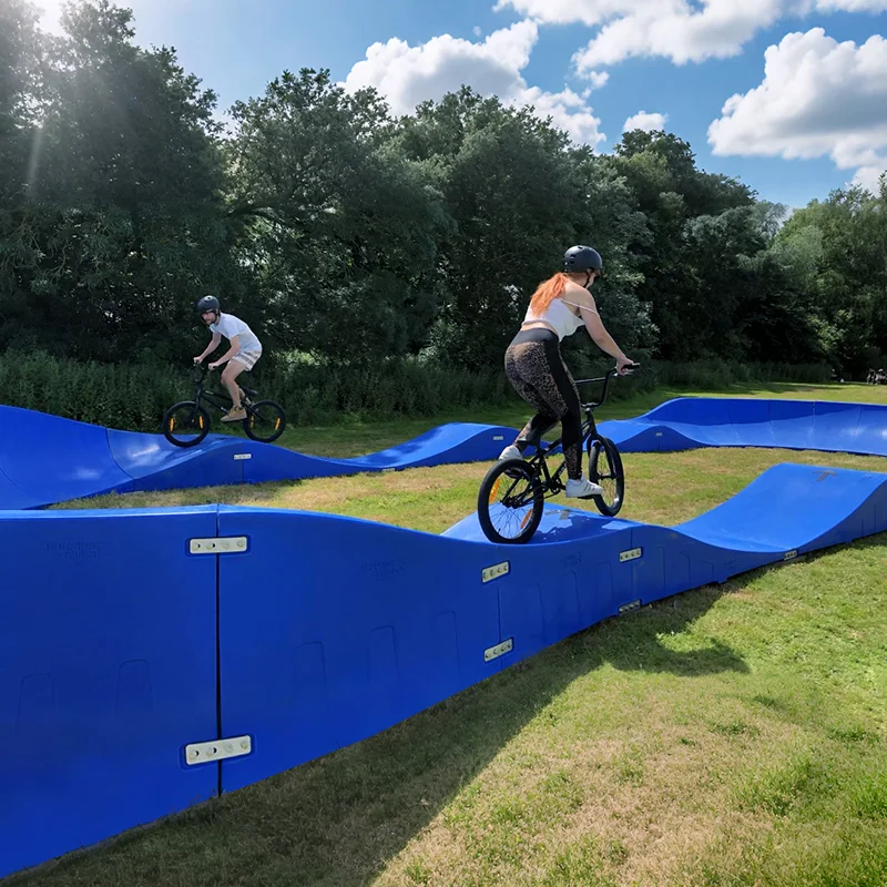 Plastic modular pump track velocity loop 2 is a sequence of roll overs  and berms  for bikes, BMX scooters and skateboards
