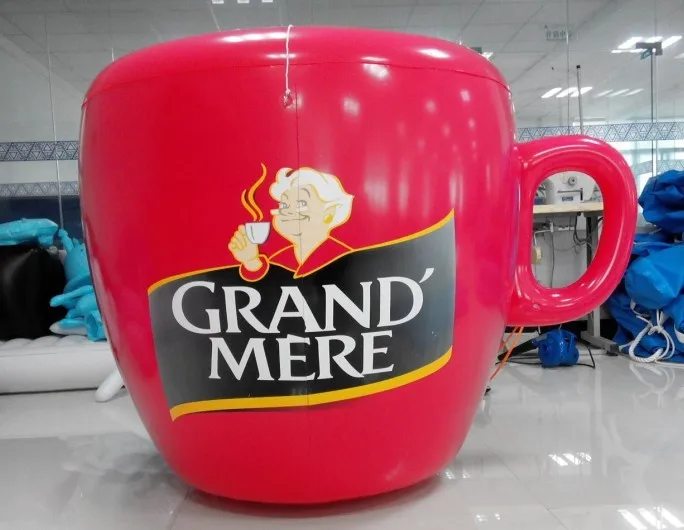 Printed 7m high 14 m long giant inflatable football player helium balloon in a kicking pose for parades