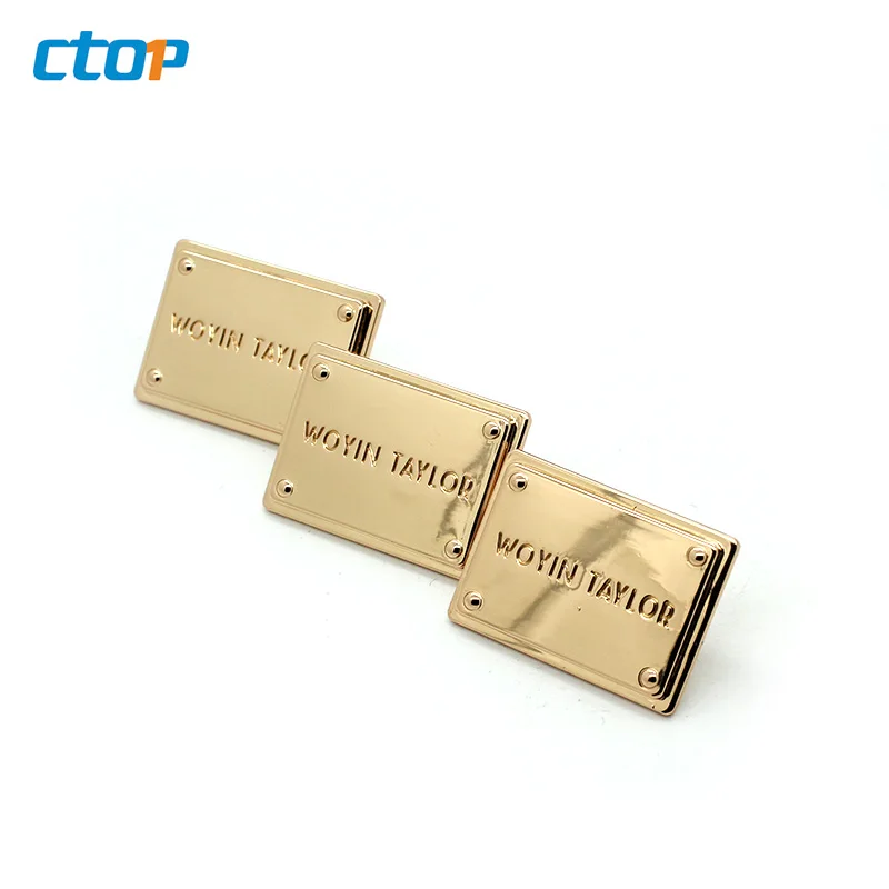 Wholesale standard environmental custom embossed metal logo plate bags metal labels for clothing