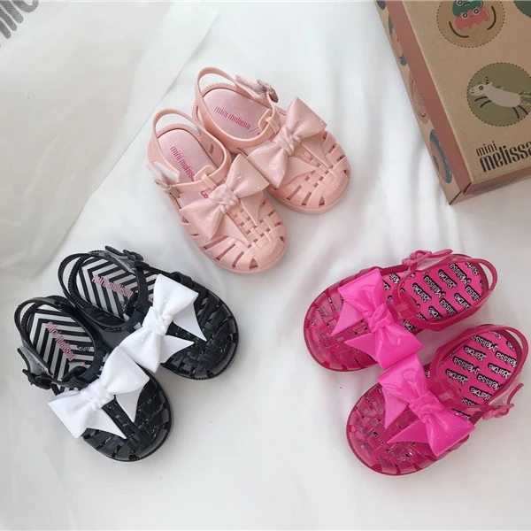 2023 mini Melissa shoes kid bowknot hollow out sandal jelly baby wrap toe soft sole beach wear resistant skid shoes