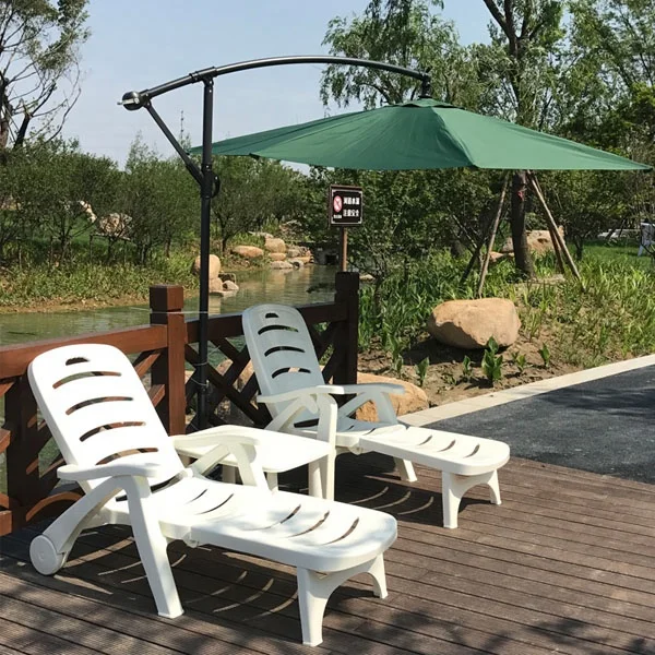 Outdoor beach hotel swimming pool plastic chaise lounge chair