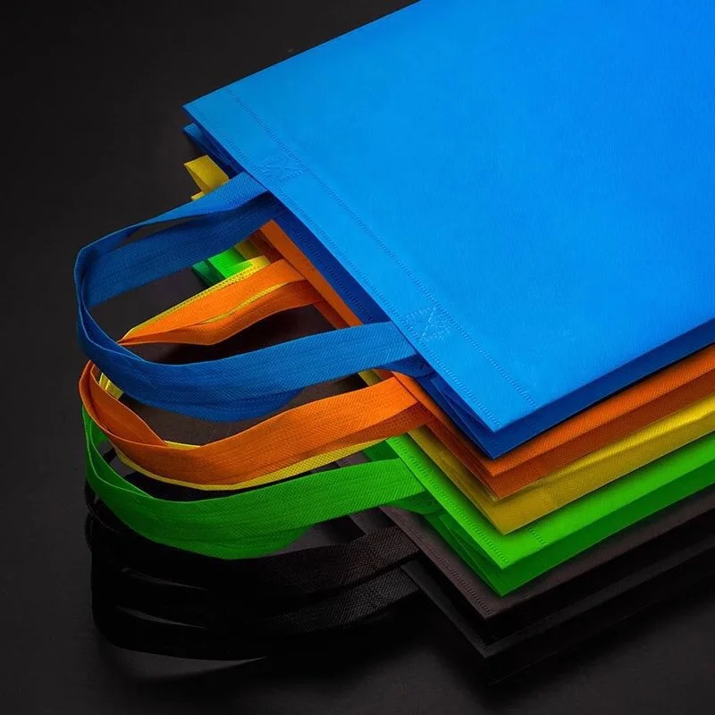 wholesale ready to ship cheap factory price reusable colorful ultrasonic non-woven handle bags for shopping