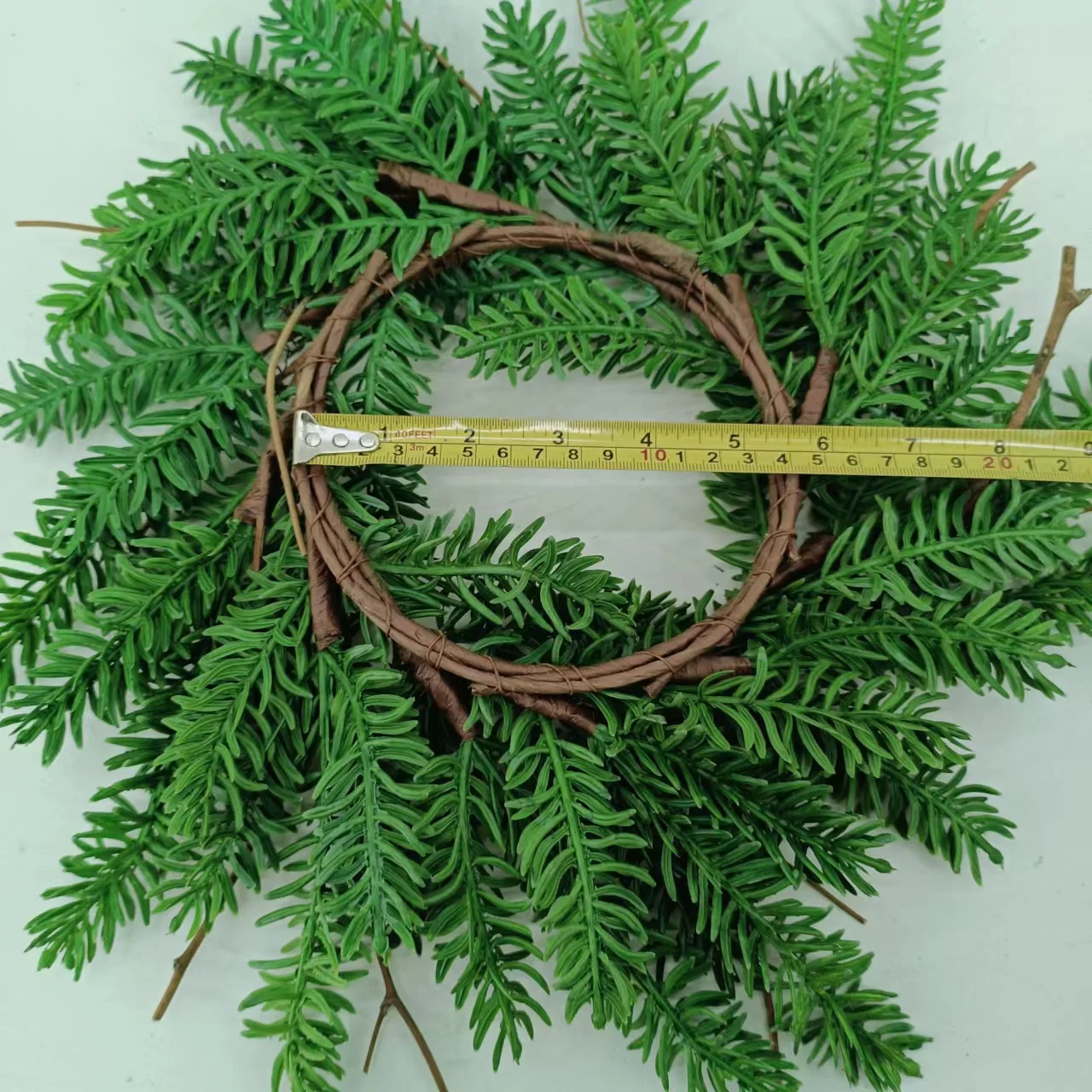 Artificial pine needles and pinecone rings wreath for Christmas