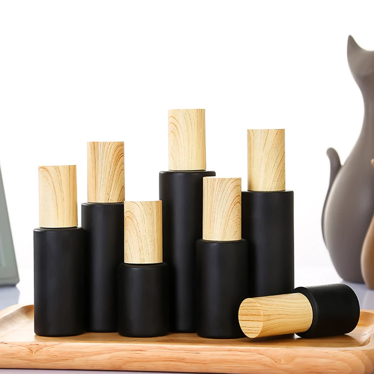 
Spot 5g 10g 15g 20g 30g 50g round shape empty refillable frost matte black glass cream jar with bamboo top cap 