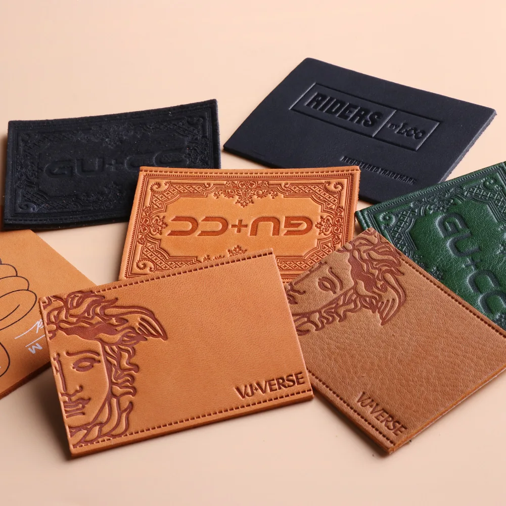 High quality logo patch embossed sewn into authentic label jeans with custom leather tags