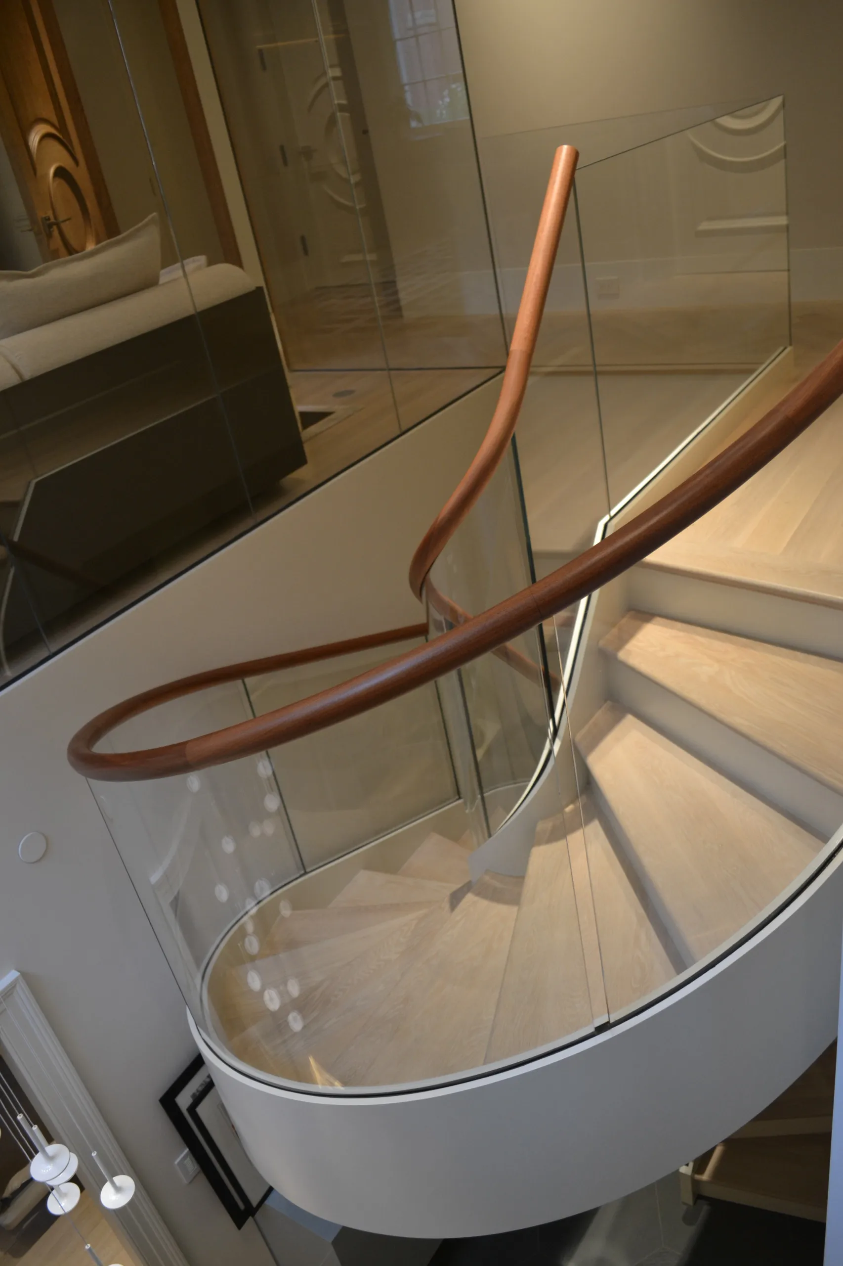 VIKO Stair The Inward-rolling Elegant White Hidden Stringer Curved Staircase Spiral Stair.