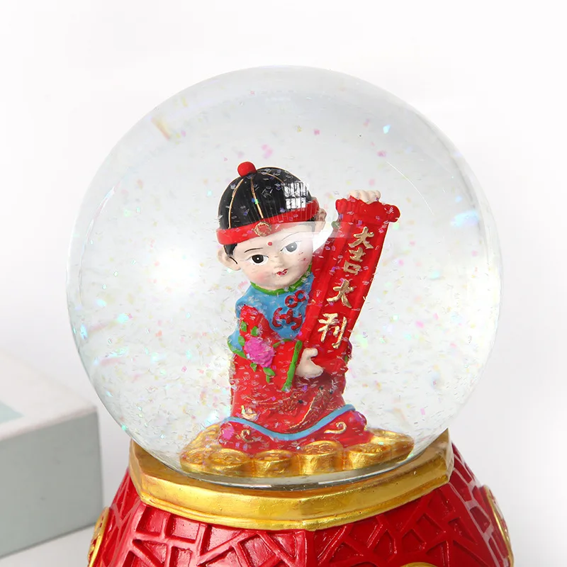 Chinese Traditional God of Wealth Golden Boys Jade Maidens Crystal Glass Snow Globe with LED Light and Music for New Year Gifts