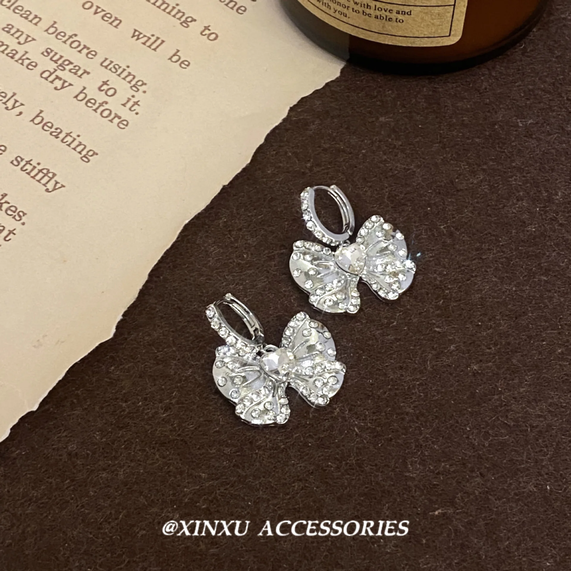 Bow ear female 2024 new fashion summer niche design sense of advanced micro-diamond earrings sweet temperament