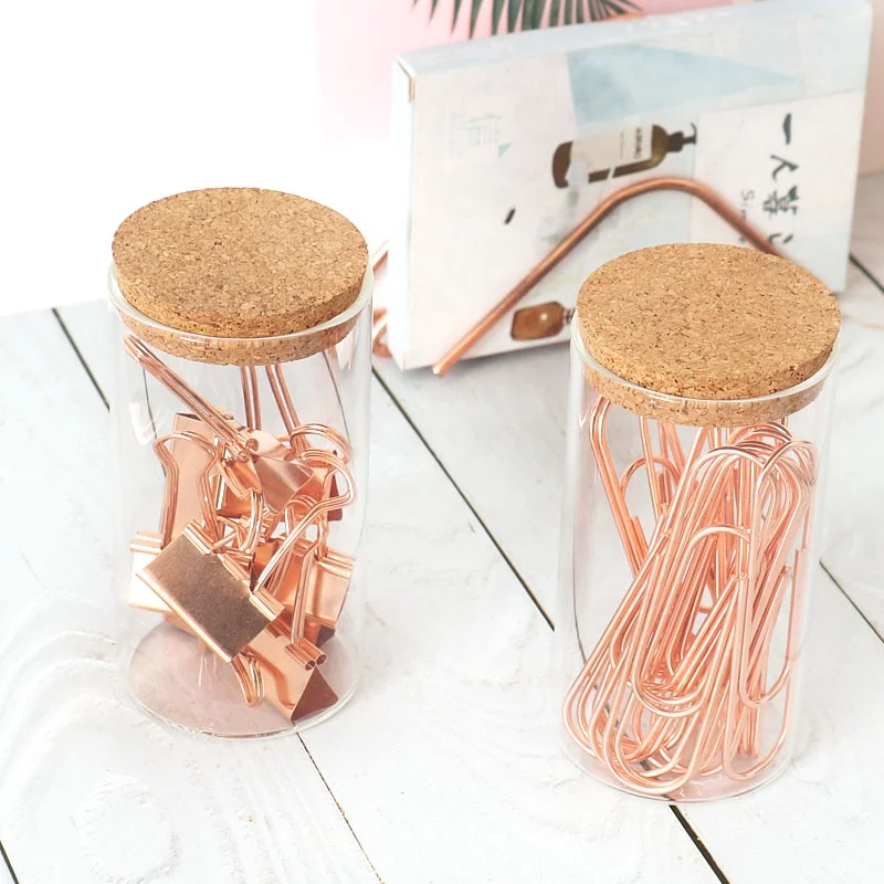 office rose gold paper clips and binder clips in glass jar