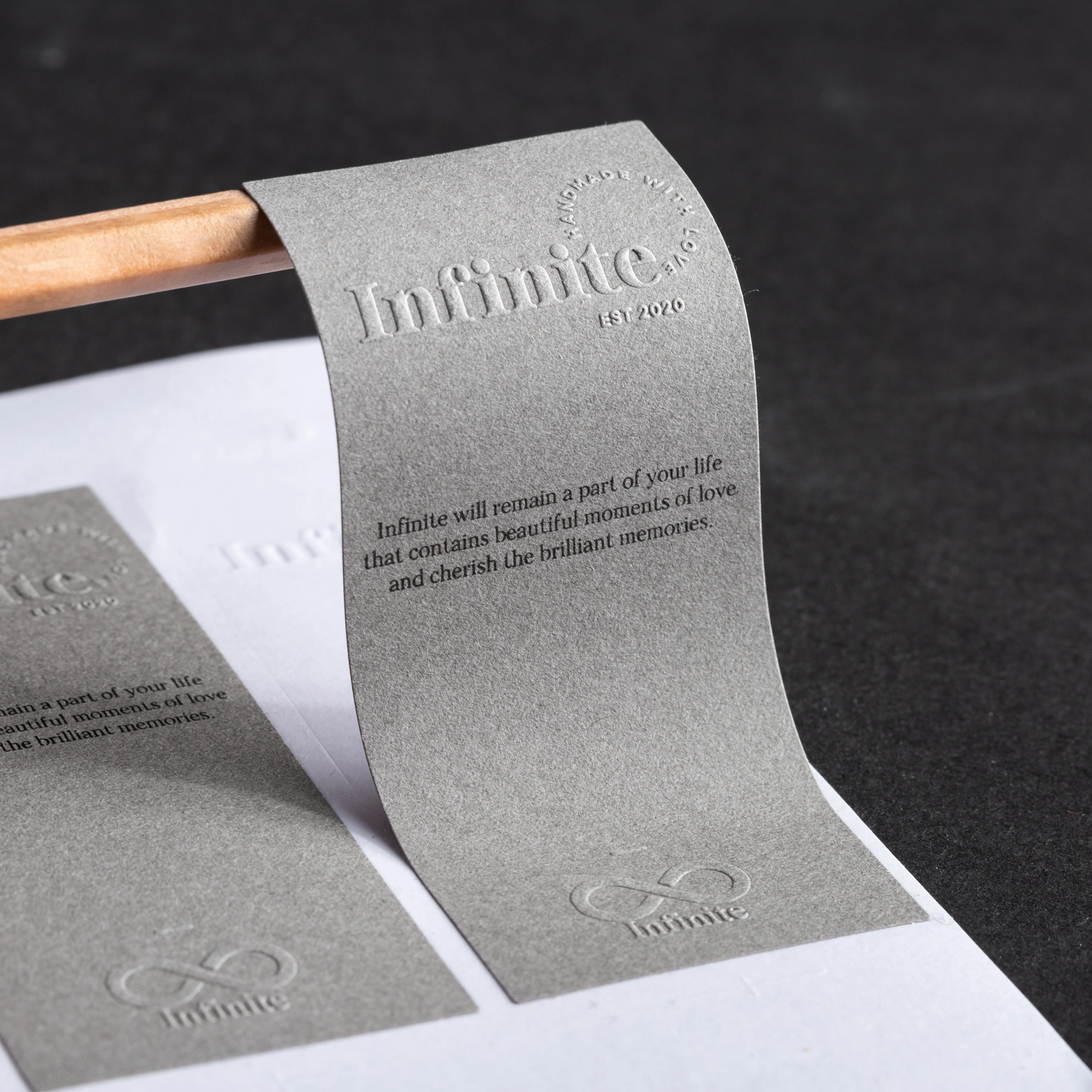 Factory luxury customized gray texture paper sticker 3d embossed logo self adhesive candle perfume labels