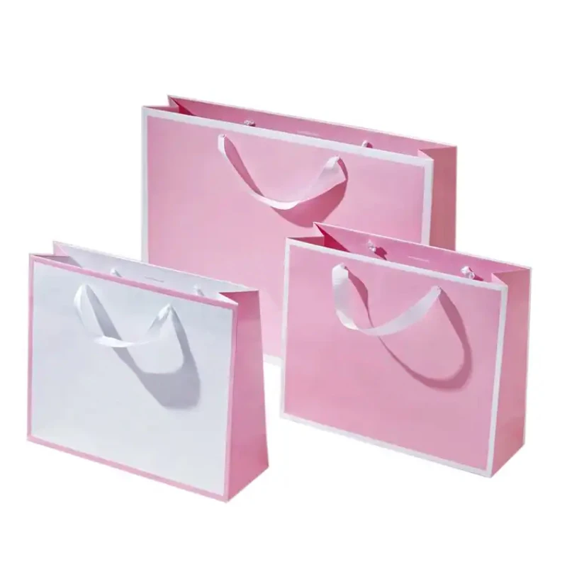 Factory wholesale custom printed brand logo bow tie design promotion luxury clothing gift shopping paper bag with handle