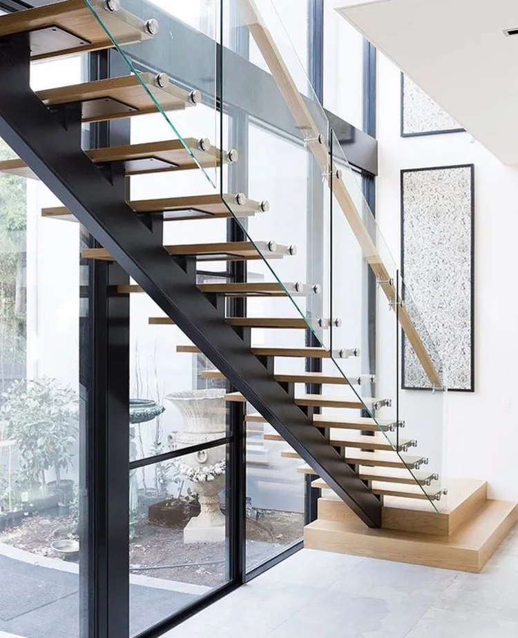 Floating stairs Single stringer steel and wood stairs  Glass railing Custom stairs