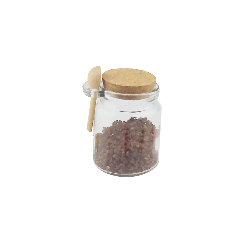 Glass jar with cork lid and wooden spoon for bath salt storage