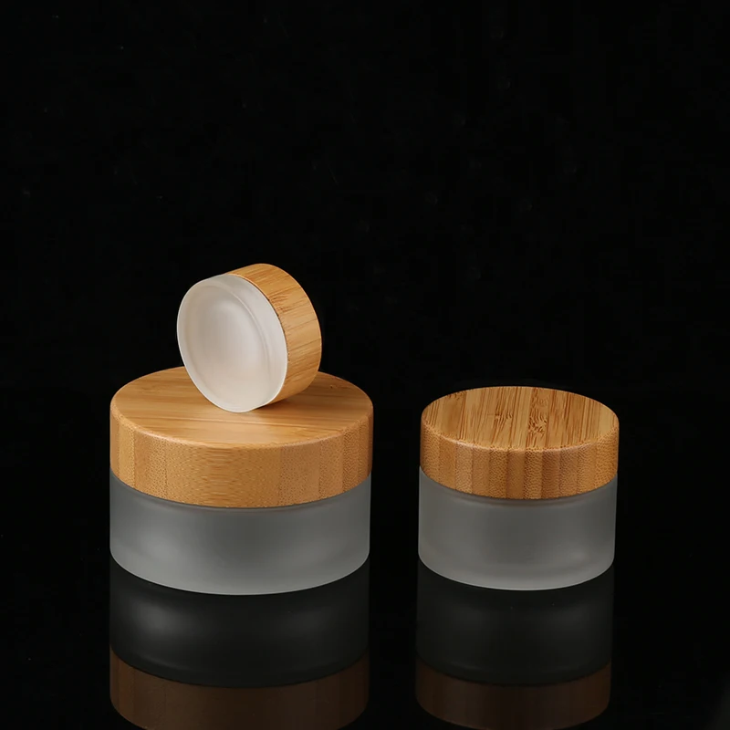Natural Factory Direct Custom 100g empty round cream glass jar clear frosted bamboo glass cosmetic jars with bamboo lids