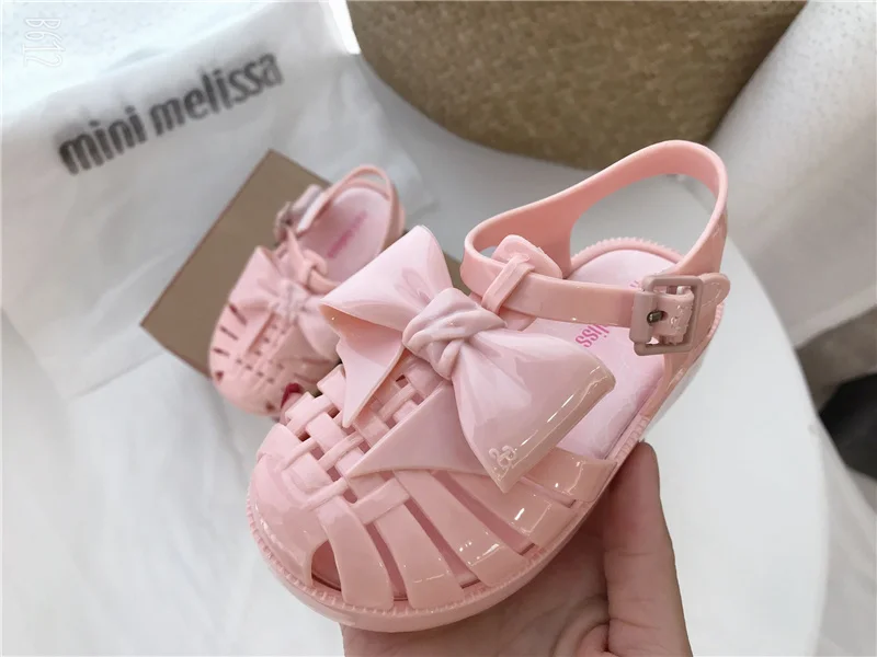 2023 mini Melissa shoes kid bowknot hollow out sandal jelly baby wrap toe soft sole beach wear resistant skid shoes