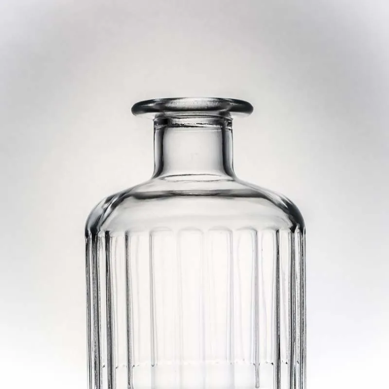 Customizable capacity embossed round shape spirit glass bottle with cork for whisky vodka tequila gin rum