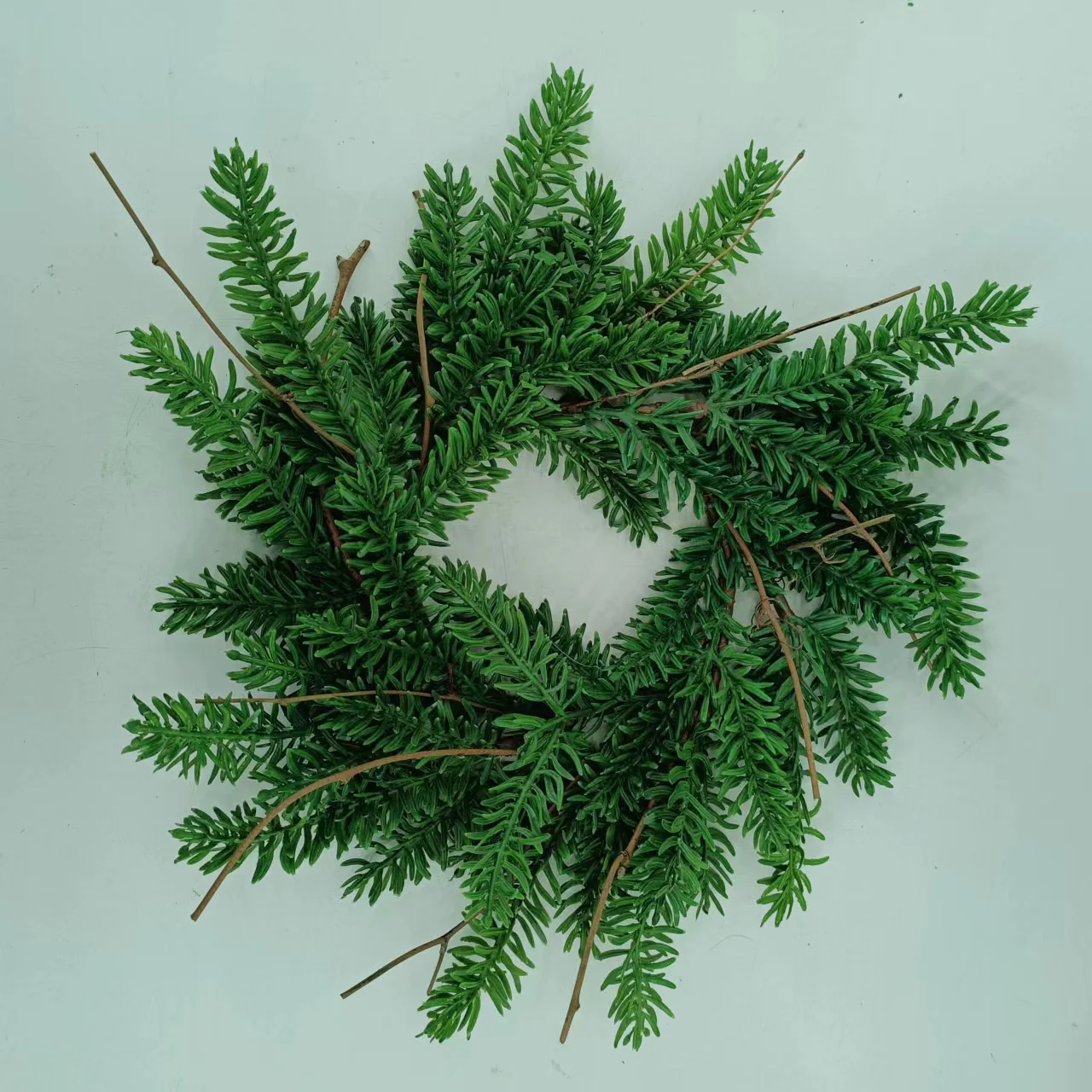 Artificial pine needles and pinecone rings wreath for Christmas