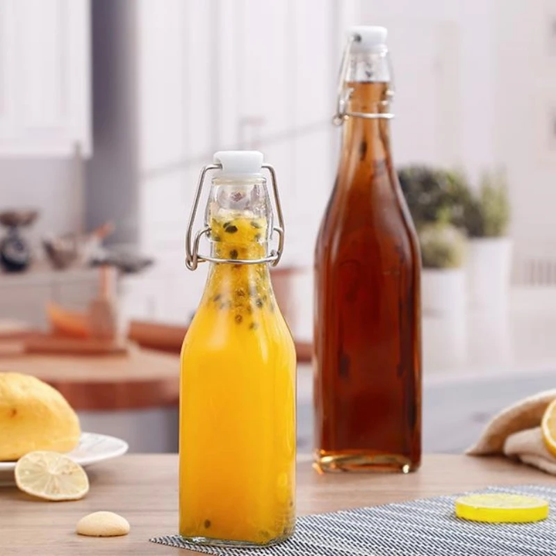 Wholesale Clasp Beverage bottle Clear Juice Drink Sealed Bottle With Lids Glass Bottle Drinking Container