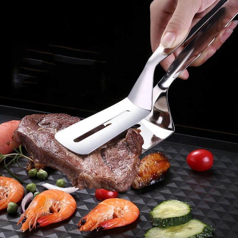 Stainless steel steak spatula barbecue with grilled fish with food with bread pancakes Korean barbecue fried fish with tongs