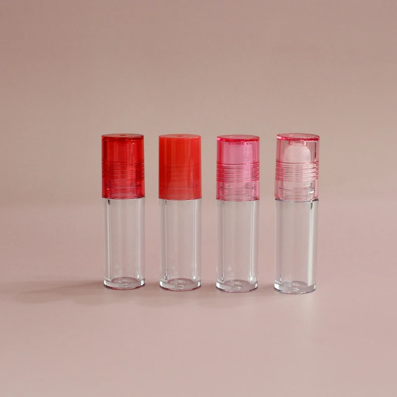 Low moq high quality round clear pink top thick wall lip oil tube  container cosmetic lip gloss packaging roll on lip gloss