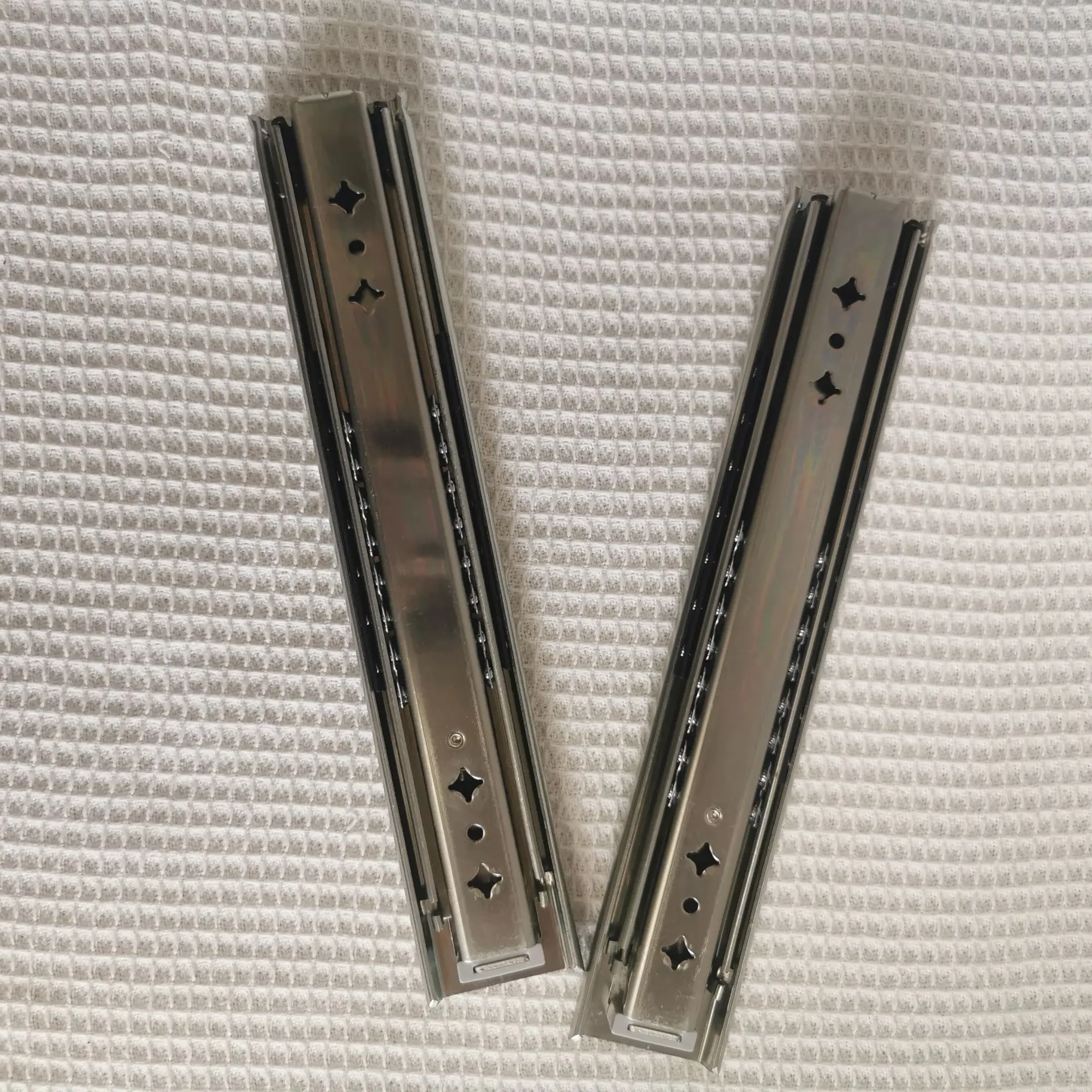 Hidden drawer slides are installed at the bottom of the heavy-duty drawer rails under the stairs