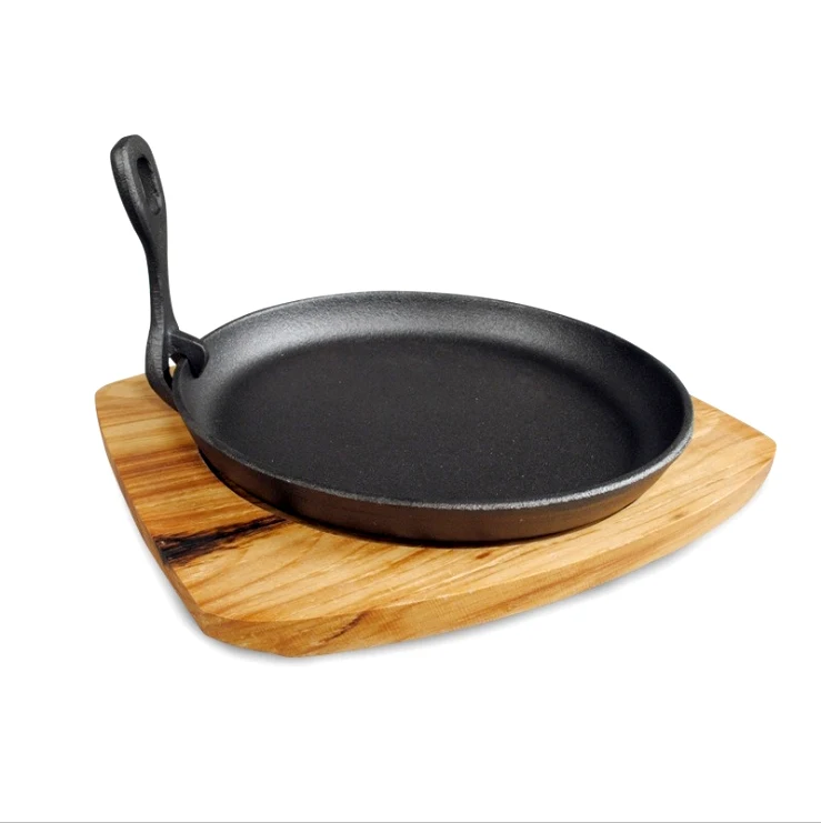 Cast iron frying pan with wooden board