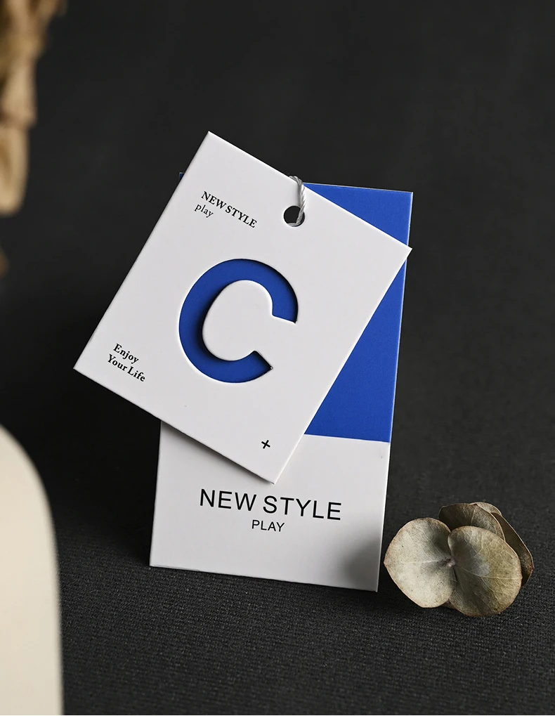 Simplified Letter Hollowed Out Process Embossed Paper Clothing Tag Design Clothing Label Color Printing Clothing Tag