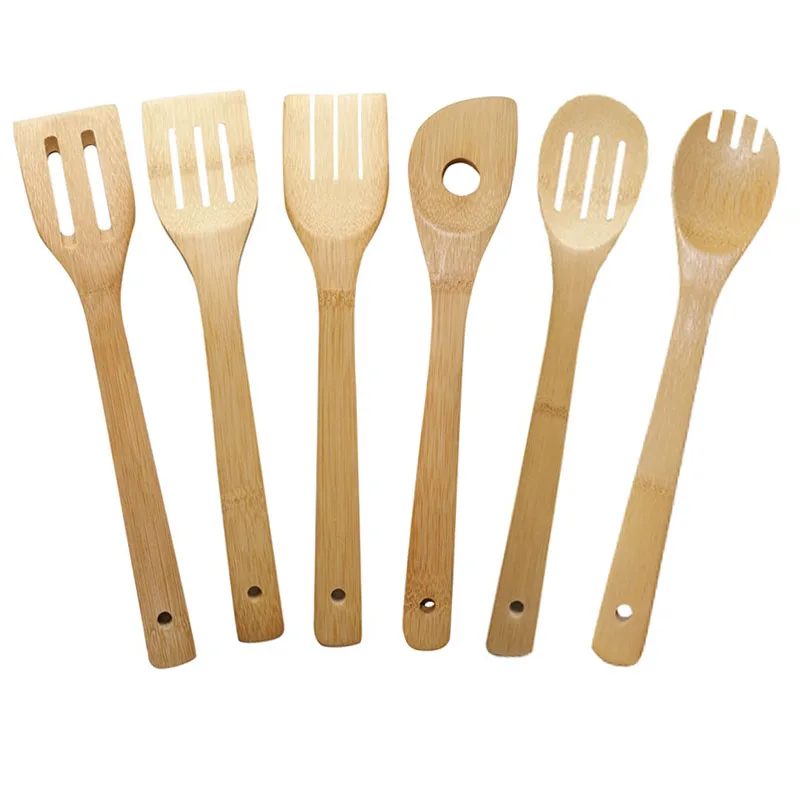 Bamboo spatula in stocked kitchen gadgets for cooking