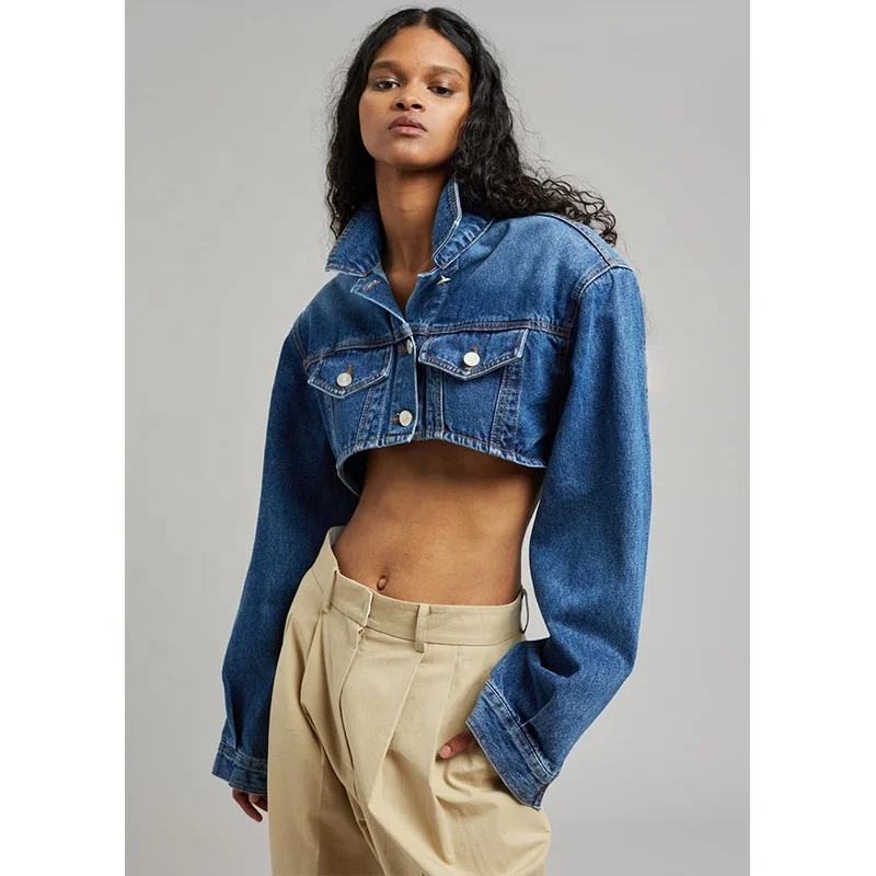 Dark Indigo Lightweight cotton denim Highly cropped profile Padded shoulders Flap front pockets Button front closure Denim jack