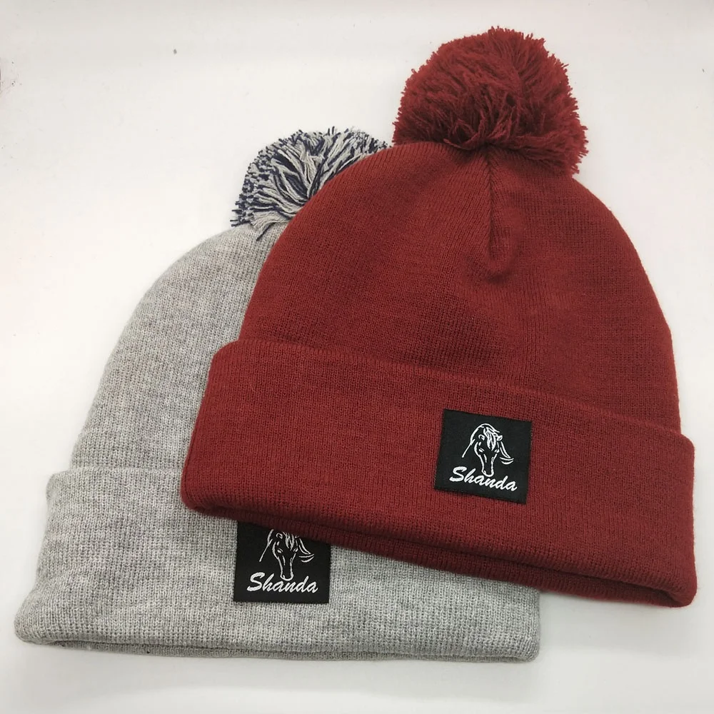 High quality machine made OEM service plain dyed custom pom pom knitted hat with tag