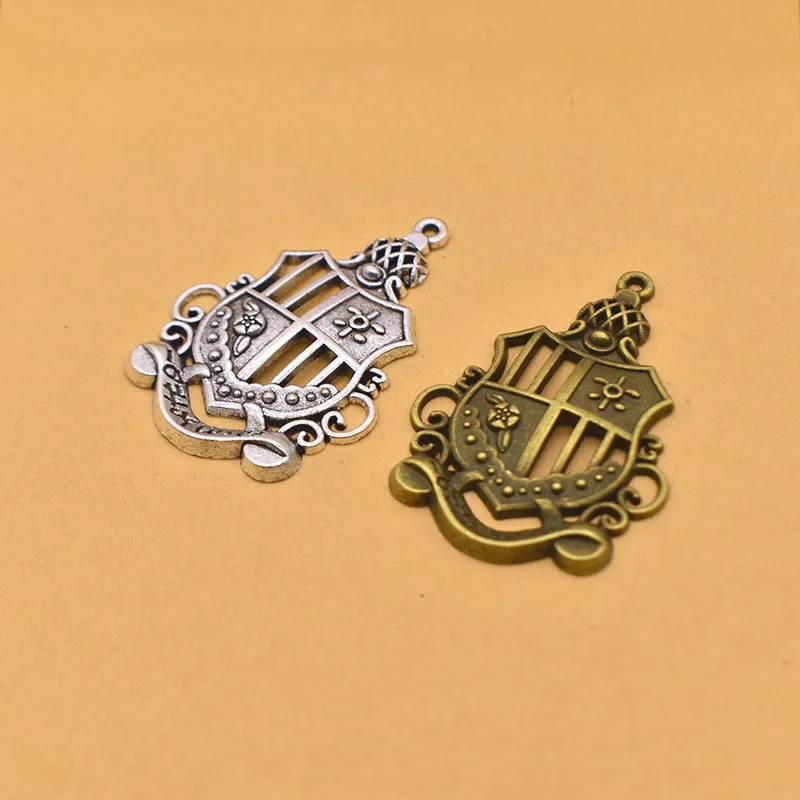 Unique and charming vintage style! Beautifully hollowed alloy crown pendant, badge, to complement your accessories!