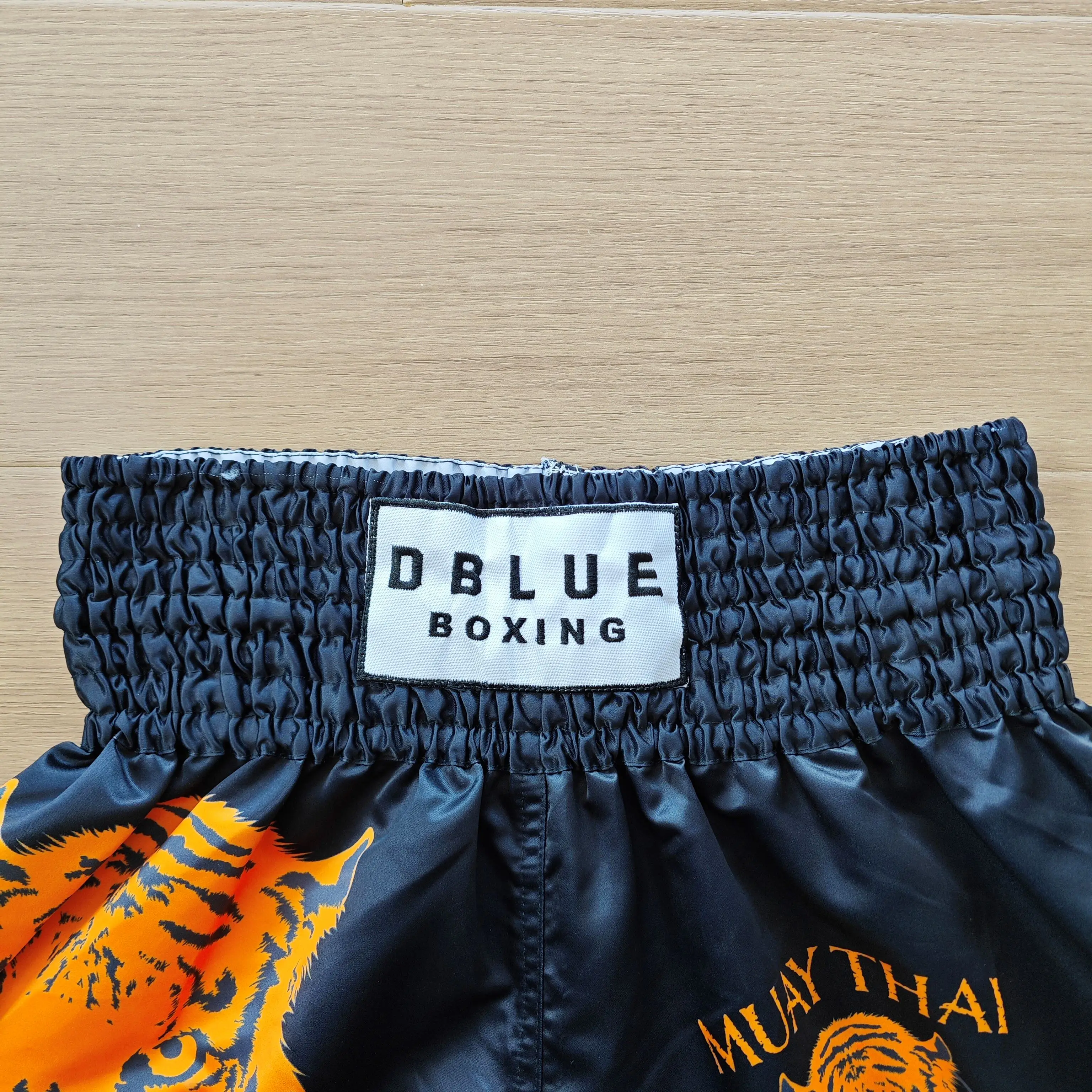 Dblue 2024 Custom Logo Satin Muay Thai Boxing Shorts for Men Wholesale MMA Fighting Wear Made from Polyester muay thai shorts