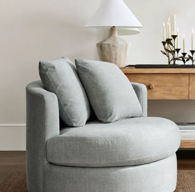 Curved silhouette and generous indoor furniture swivel upholstered comfortable sofa living room chair