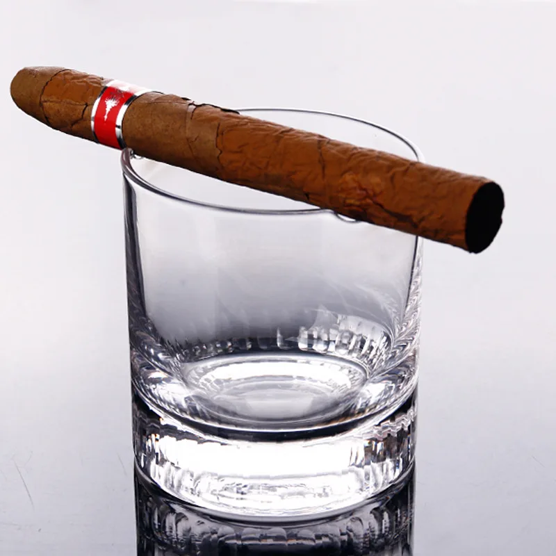 Cigar holding whiskey glass