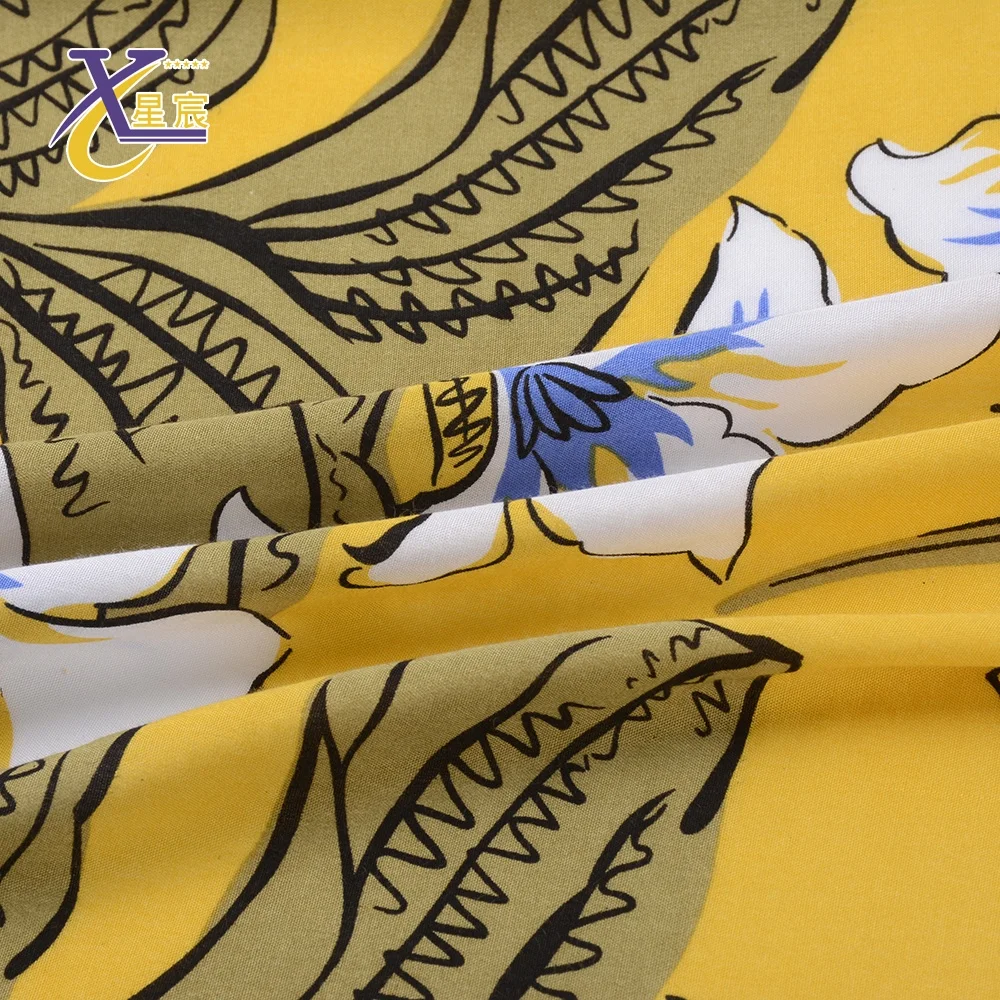 Xingchen Good quality garment material stock lots classic bright yellow floral rayon printed woven fabric