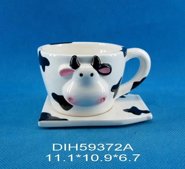 Handpainted ceramic cow shaped cup and saucer