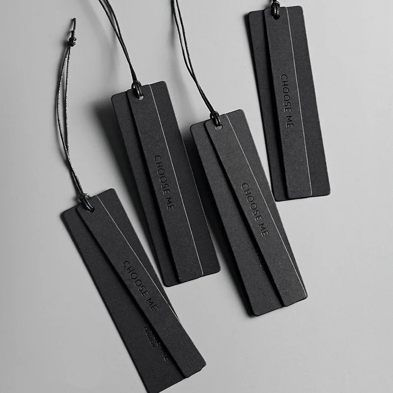 Custom thick black paper uv printing swing hang tags brand name luxury metal eyelet clothing garment hang tag with safety pin