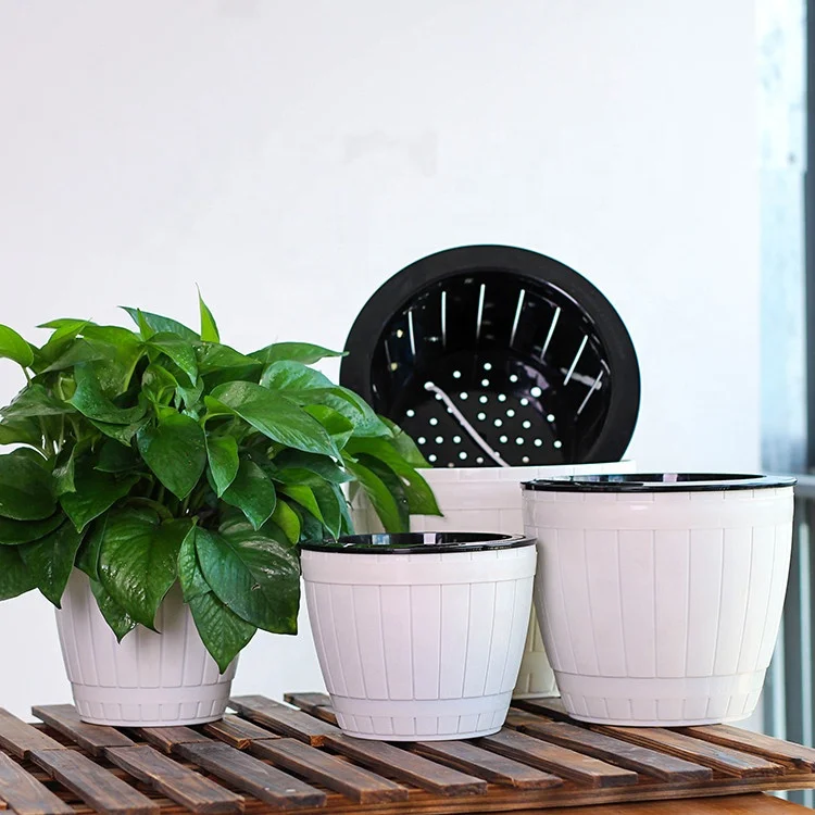 Self watering plastic flower plant pot for indoor