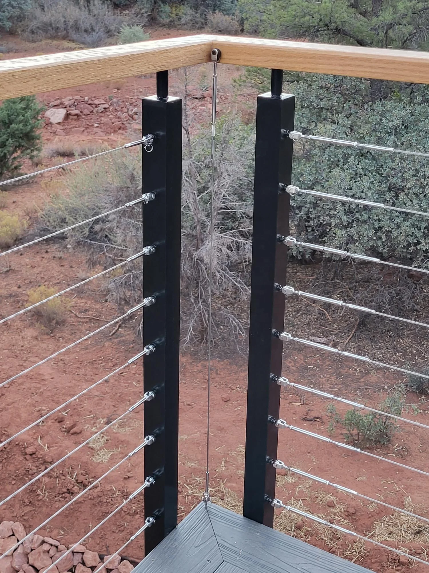 Black aluminum cable railing post with wooden handrail cable railing design