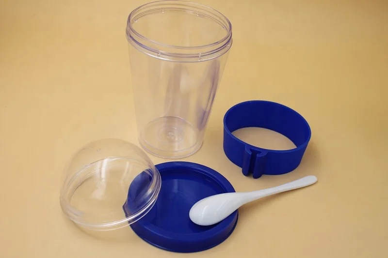 Plastic cereal cup with spoon, travel mug with cruesli compartment
