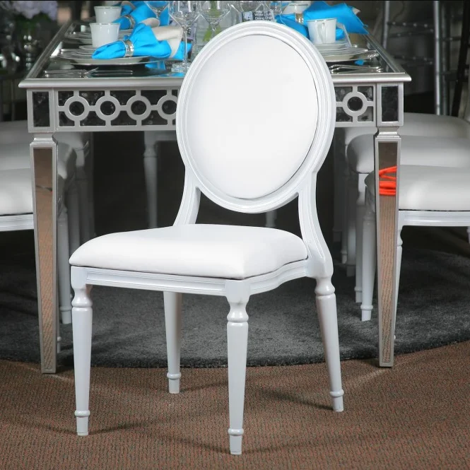 Close up stacking white metal aluminum round back banquet hall wedding event chairs