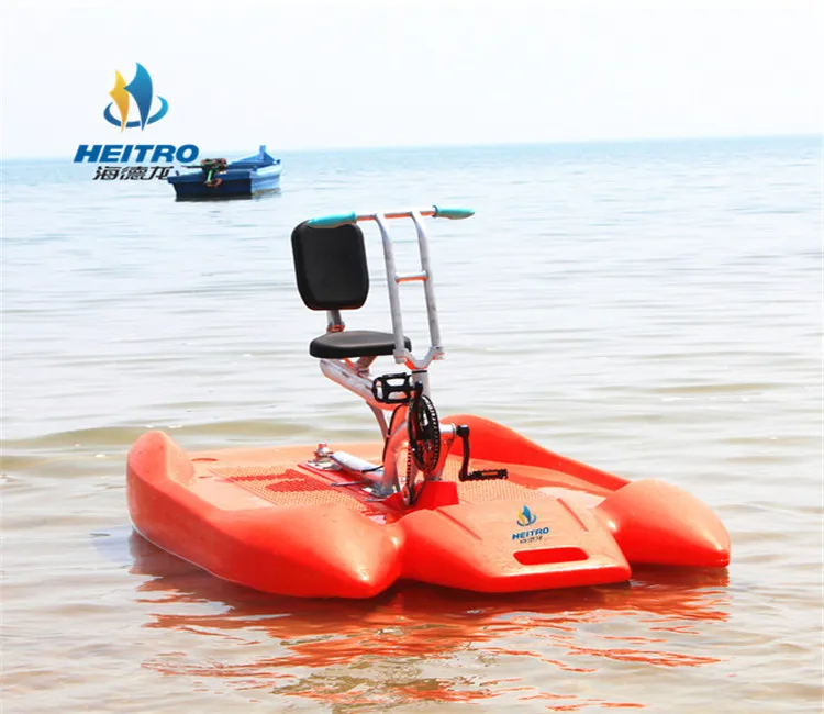 two persons surf water exercise bike /pedal boat bicycle riding on the lake