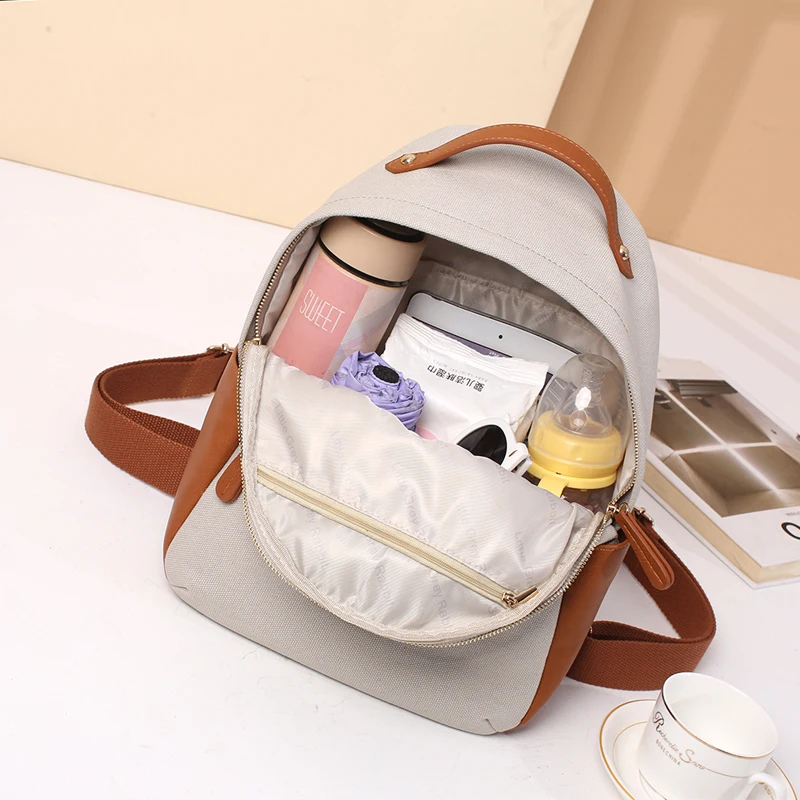 Mini canvas and vegan leather diaper bags multifunction baby bags including changing mat and stroller straps