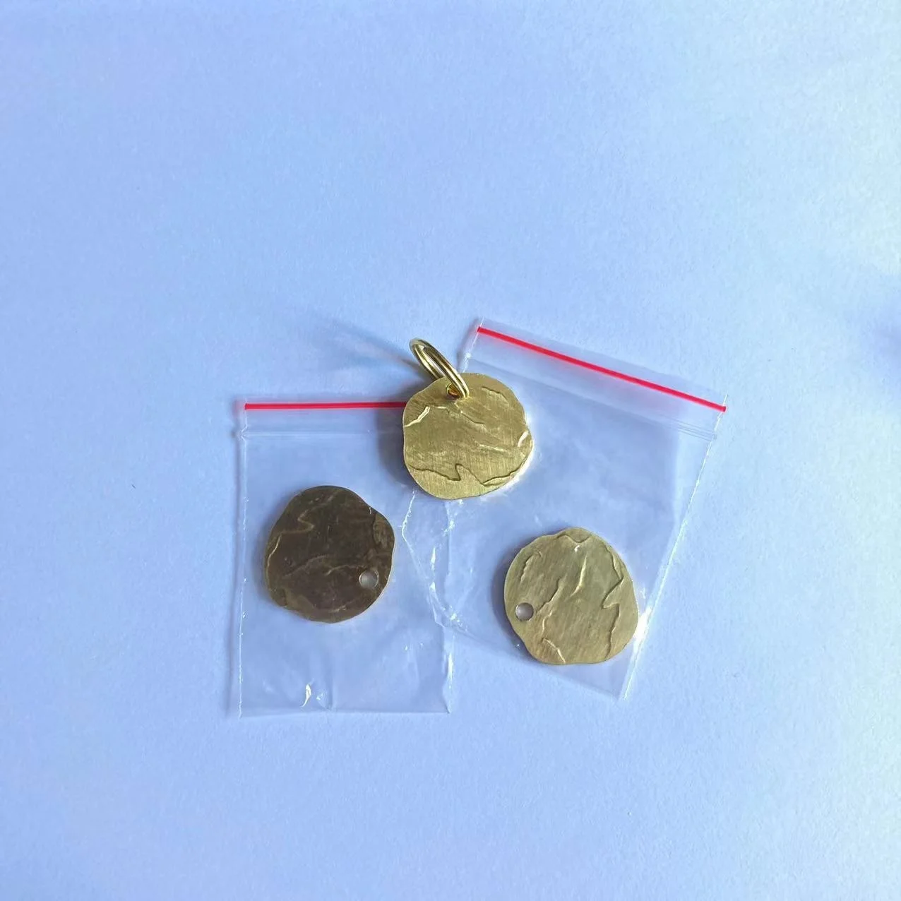 Custom logo engraved solid brass rough and not smooth round blank brass dog tags with struck effect