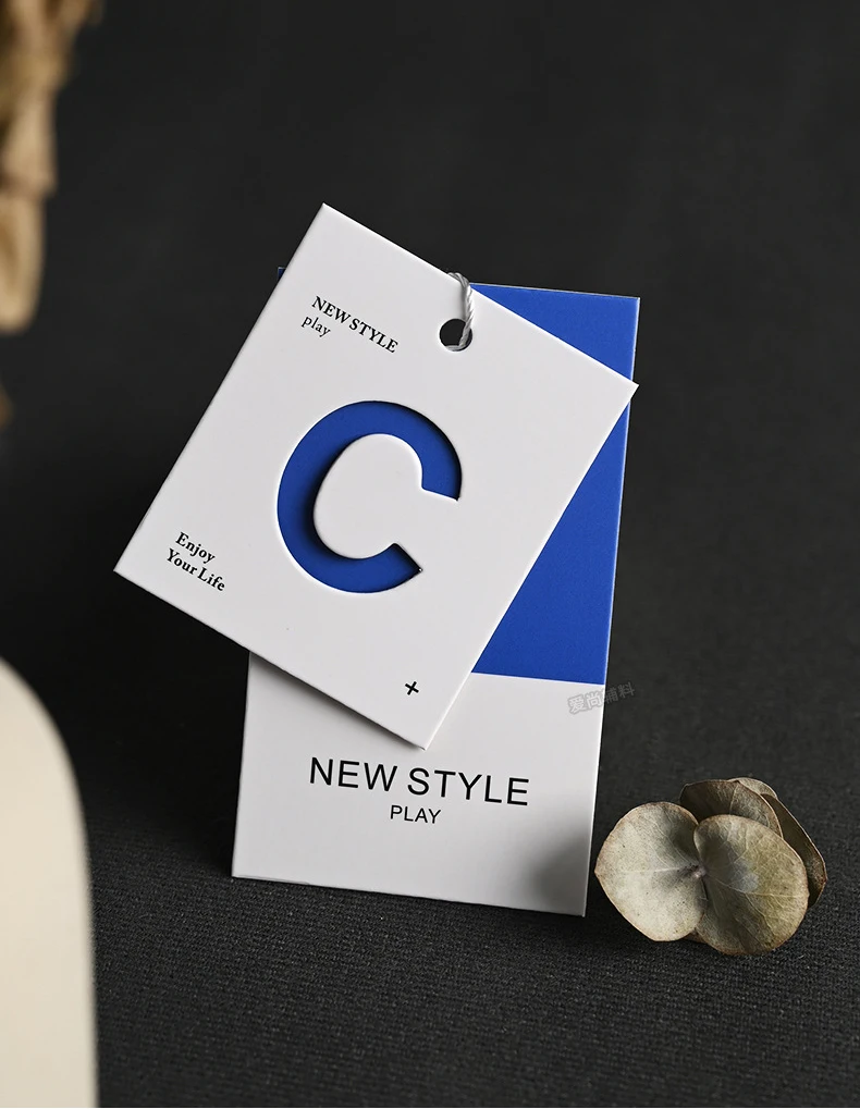 Simplified Letter Hollowed Out Process Embossed Paper Clothing Tag Design Clothing Label Color Printing Clothing Tag
