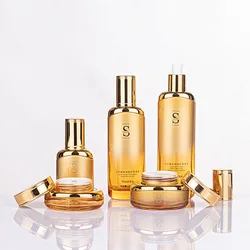 Luxury BaoMo China Glass Factory skin care packaging gold cosmetic glass cream jars and pump bottles
