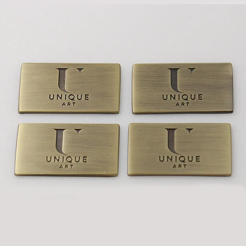 
Waterproof Gold Small Sew On Brand Stamped Ingraving Clothing Swimwear Swimsuits Scarf Metal Logo Plate Label Tag For Garment 